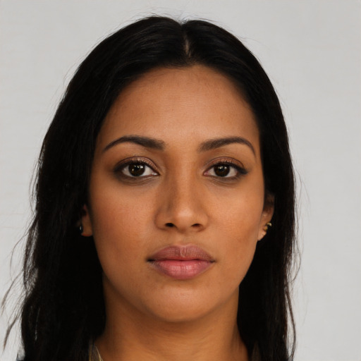 Joyful latino young-adult female with long  brown hair and brown eyes