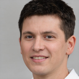 Joyful white young-adult male with short  brown hair and brown eyes