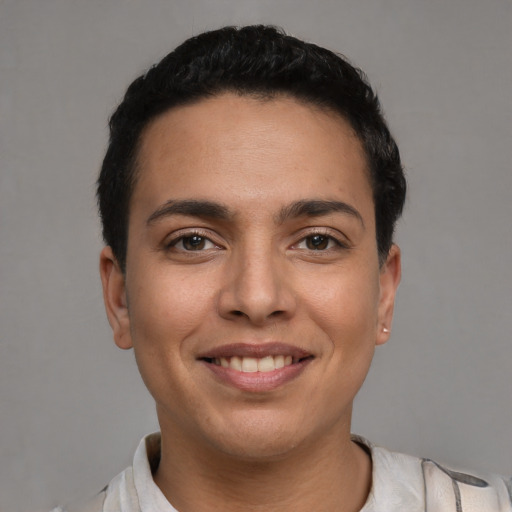 Joyful latino young-adult male with short  brown hair and brown eyes