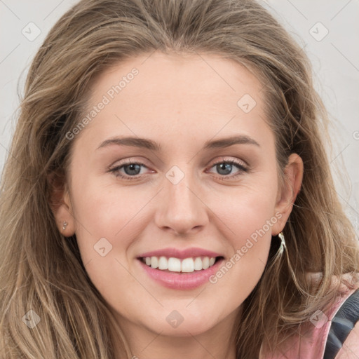 Joyful white young-adult female with long  brown hair and blue eyes