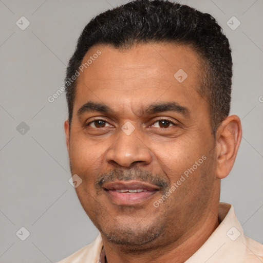 Joyful latino adult male with short  black hair and brown eyes