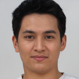 Joyful asian young-adult male with short  brown hair and brown eyes