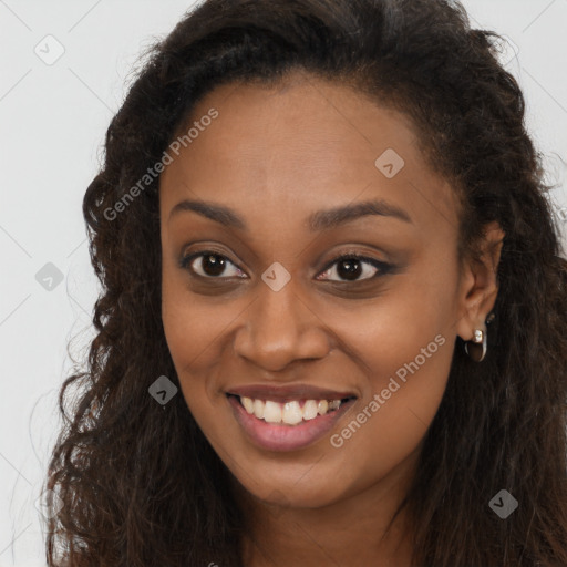 Joyful black young-adult female with long  brown hair and brown eyes