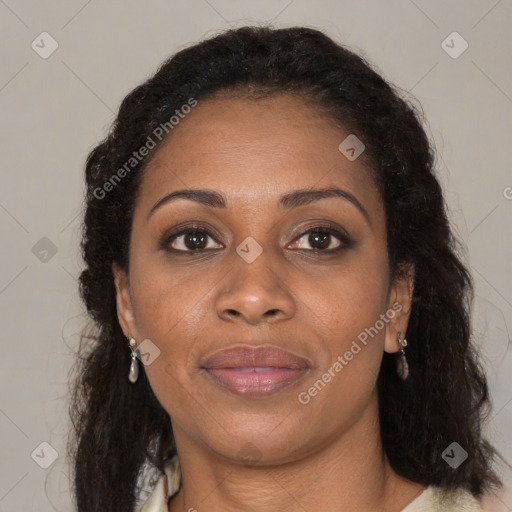 Joyful black young-adult female with long  brown hair and brown eyes