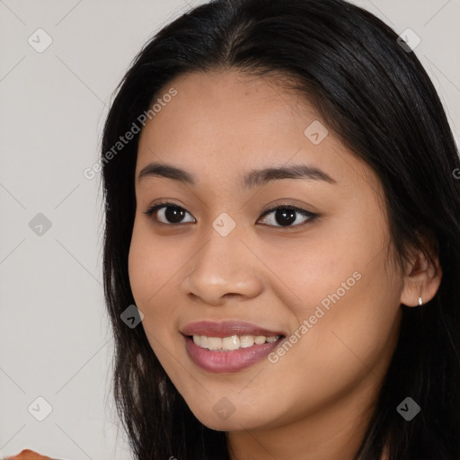 Joyful asian young-adult female with long  brown hair and brown eyes