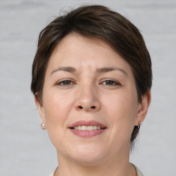 Joyful white adult female with short  brown hair and brown eyes