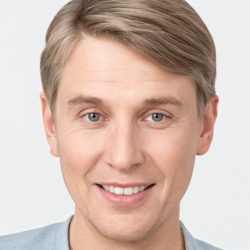 Joyful white adult male with short  brown hair and grey eyes