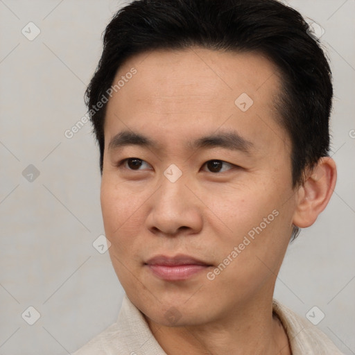 Joyful asian young-adult male with short  brown hair and brown eyes