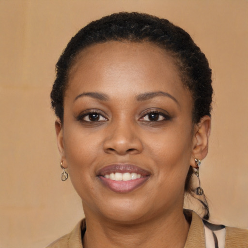 Joyful black young-adult female with long  brown hair and brown eyes