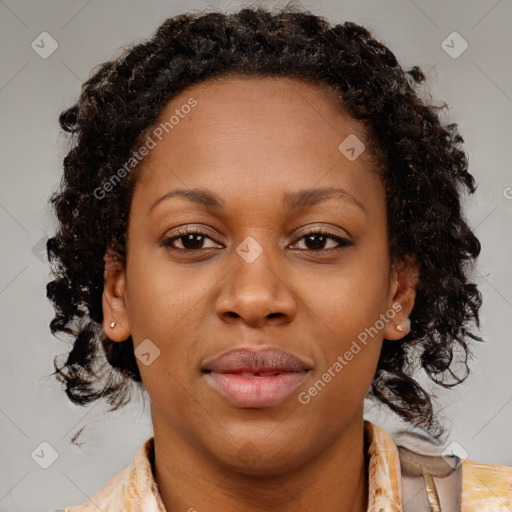 Joyful black adult female with medium  brown hair and brown eyes
