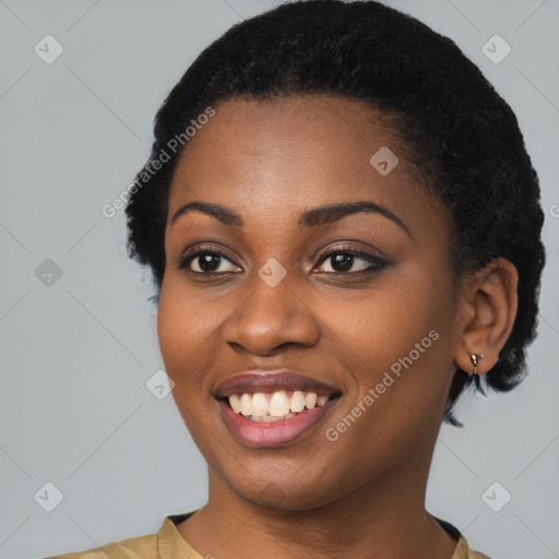 Joyful black young-adult female with short  black hair and brown eyes