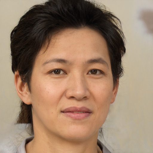 Joyful white adult female with short  brown hair and brown eyes