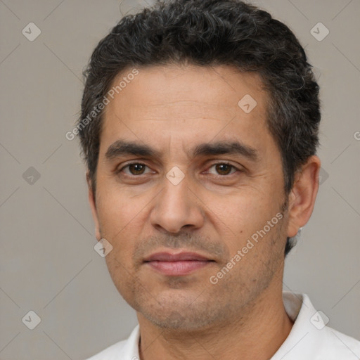 Joyful white adult male with short  black hair and brown eyes