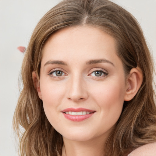 Joyful white young-adult female with long  brown hair and green eyes