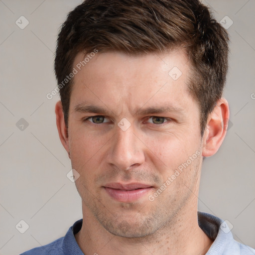 Joyful white adult male with short  brown hair and grey eyes