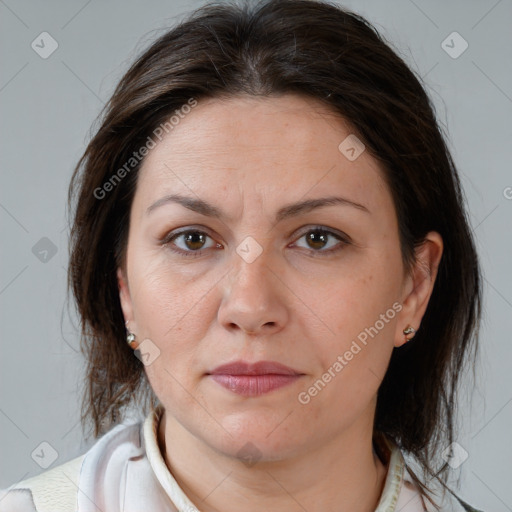 Joyful white adult female with medium  brown hair and brown eyes