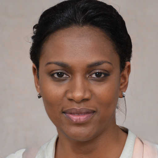 Joyful black young-adult female with short  black hair and brown eyes