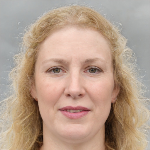 Joyful white adult female with medium  brown hair and blue eyes