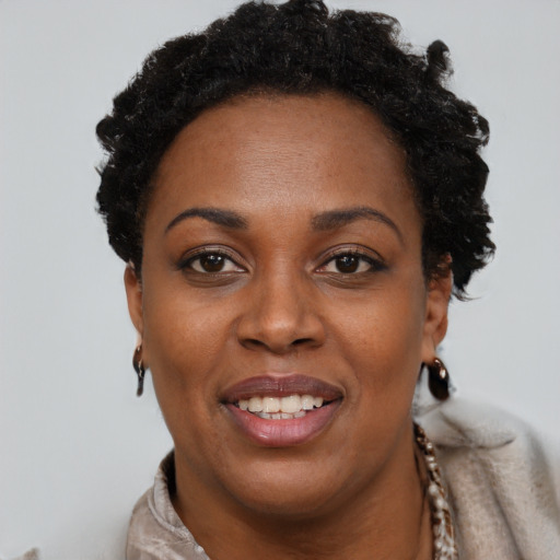 Joyful black adult female with short  brown hair and brown eyes