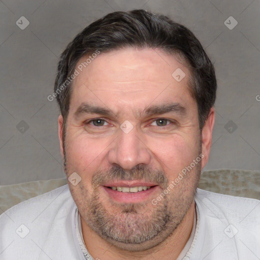 Joyful white adult male with short  black hair and brown eyes