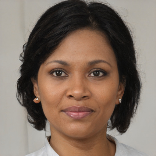 Joyful black young-adult female with medium  brown hair and brown eyes