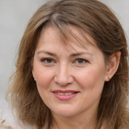 Joyful white adult female with long  brown hair and brown eyes