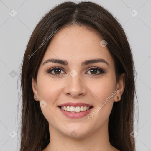 Joyful white young-adult female with long  brown hair and brown eyes