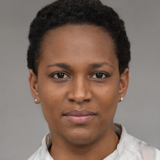 Joyful black young-adult female with short  brown hair and brown eyes