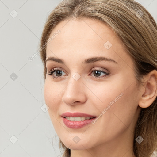 Joyful white young-adult female with long  brown hair and grey eyes