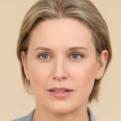 Joyful white young-adult female with medium  brown hair and blue eyes