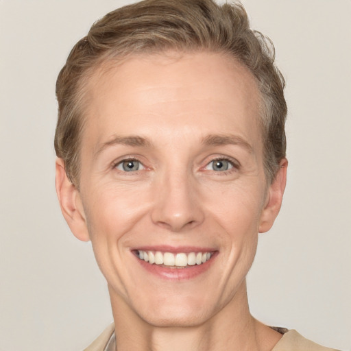 Joyful white adult female with short  brown hair and grey eyes