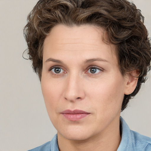 Joyful white adult female with short  brown hair and grey eyes