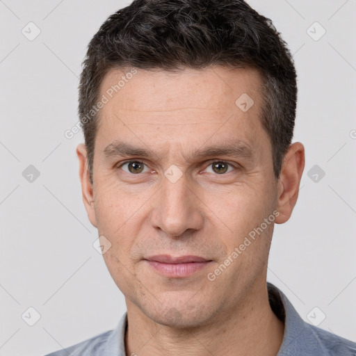 Joyful white adult male with short  brown hair and brown eyes