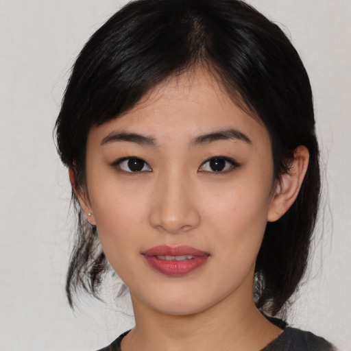 Joyful asian young-adult female with medium  black hair and brown eyes