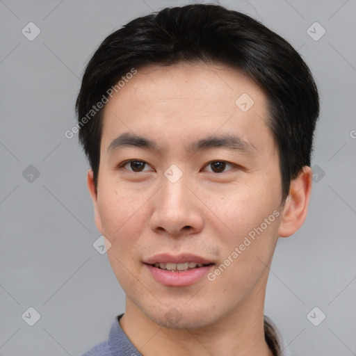 Joyful asian young-adult male with short  brown hair and brown eyes