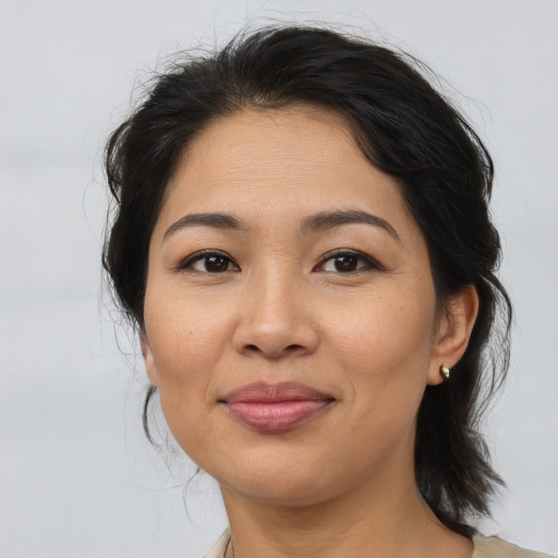 Joyful asian young-adult female with medium  brown hair and brown eyes