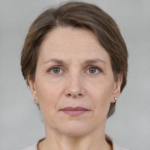 Joyful white adult female with medium  brown hair and grey eyes