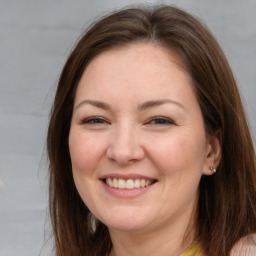 Joyful white adult female with long  brown hair and brown eyes