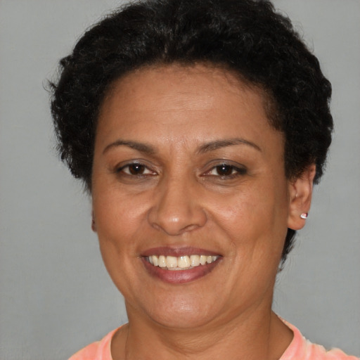 Joyful latino adult female with short  brown hair and brown eyes