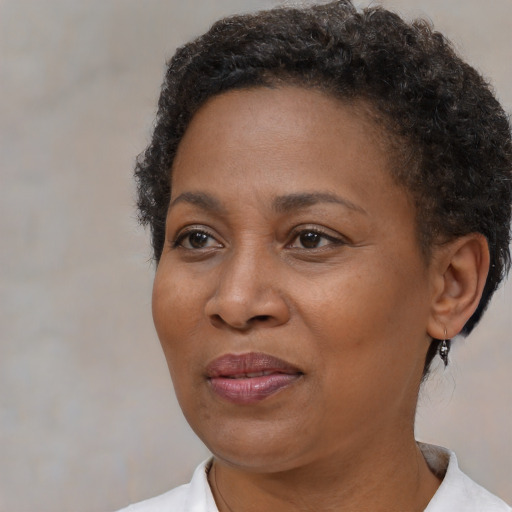 Joyful black adult female with short  brown hair and brown eyes