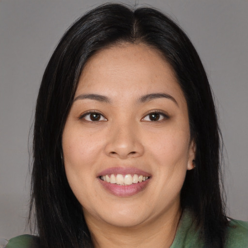 Joyful asian young-adult female with long  brown hair and brown eyes