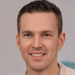 Joyful white adult male with short  brown hair and brown eyes