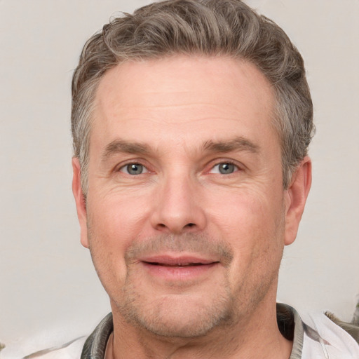 Joyful white adult male with short  brown hair and grey eyes