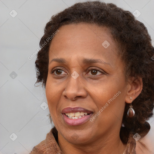 Joyful black adult female with medium  brown hair and brown eyes