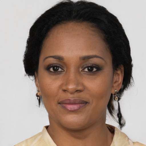 Joyful black young-adult female with medium  black hair and brown eyes