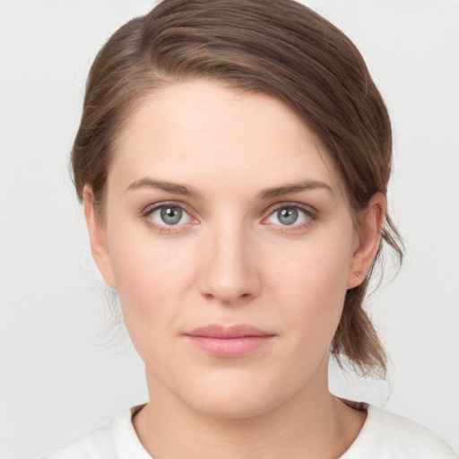 Joyful white young-adult female with medium  brown hair and grey eyes