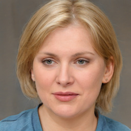Joyful white young-adult female with medium  brown hair and blue eyes