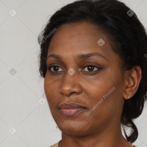 Joyful black adult female with medium  brown hair and brown eyes