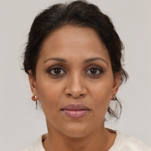 Joyful latino adult female with short  brown hair and brown eyes