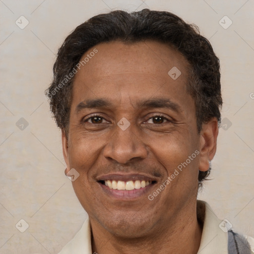 Joyful latino adult male with short  brown hair and brown eyes